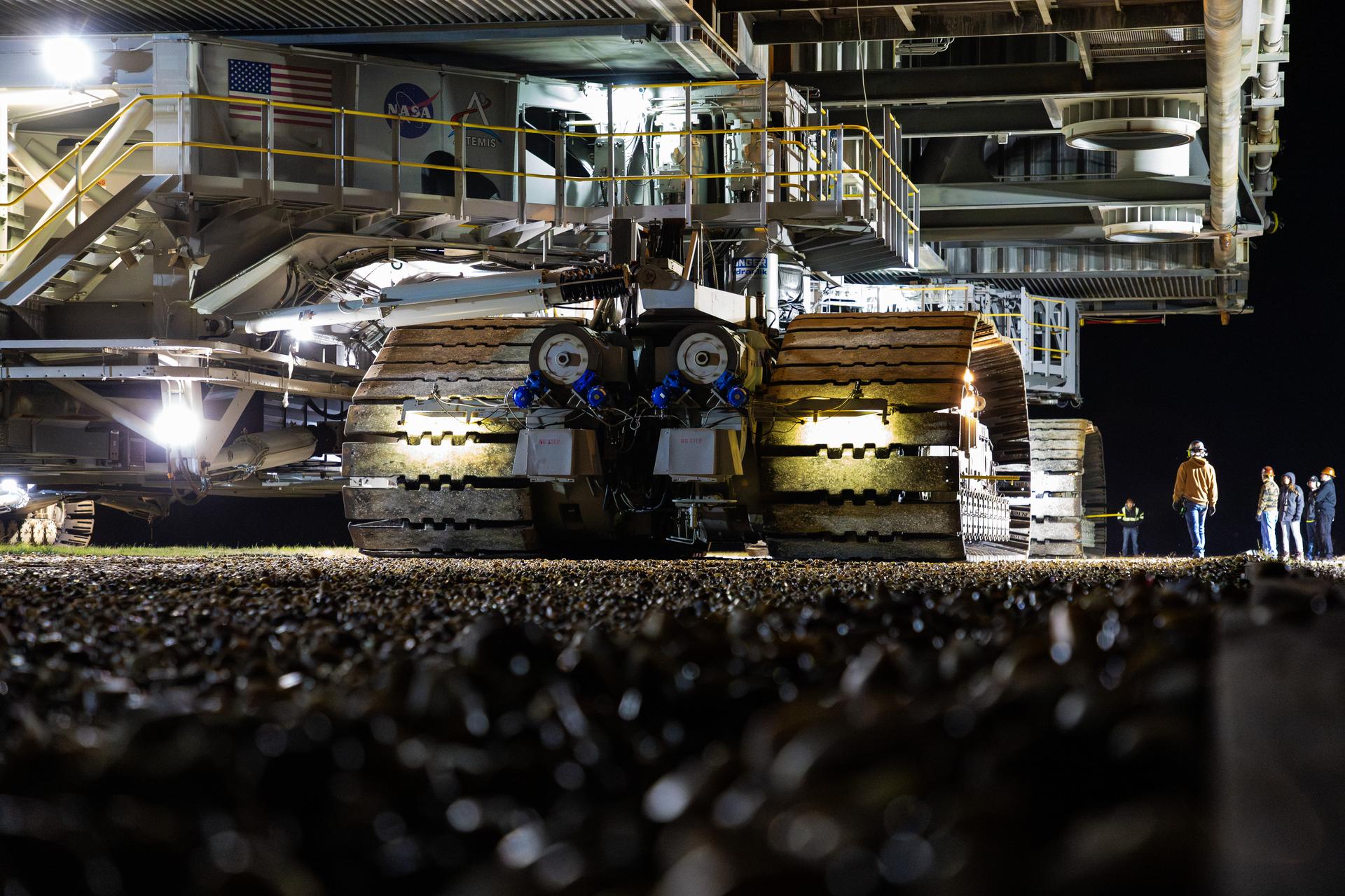 This image shows NASA’s SLS (Space Launch System) and Orion spacecraft rolling out of the Vehicle Assembly Building at NASA’s Kennedy Space Center. NASA's massive Crawler-Transporter, upgraded for the Artemis program, carries the powerful SLS rocket and Orion spacecraft on the Mobile Launcher from the Vehicle Assembly Building to Launch Pad 39B at Kennedy Space Center in preparation for the Artemis II mission.